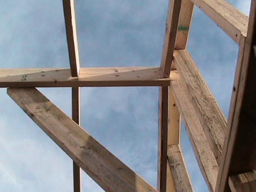 A wooden structure with sky in the background.