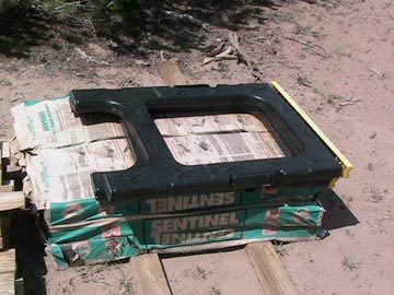 A black plastic object sitting on top of cardboard.